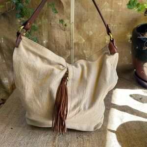 HOBO International Canvas Purse tan with brown leather strap tassel and bottom.